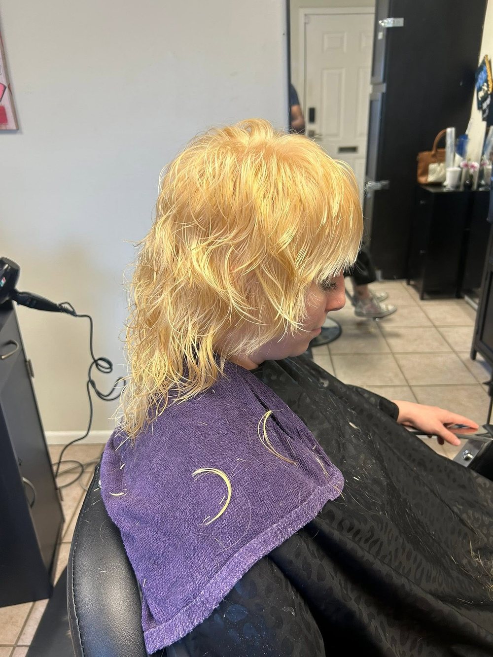 A client with freshly colored blonde hair in the chair